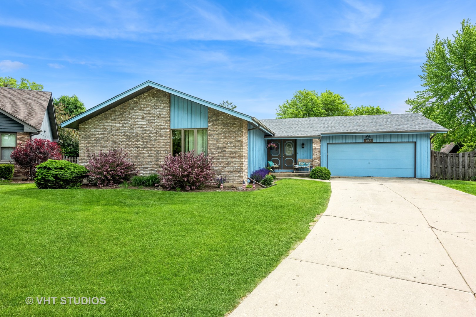 577 Yellowstone Drive Elgin, IL 60123 - Photo 2 of 30 a front view of a house with a garden
