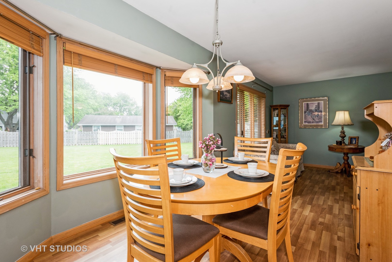 577 Yellowstone Drive Elgin, IL 60123 - Photo 7 of 30 a view of a dining room with furniture a chandelier and large windows