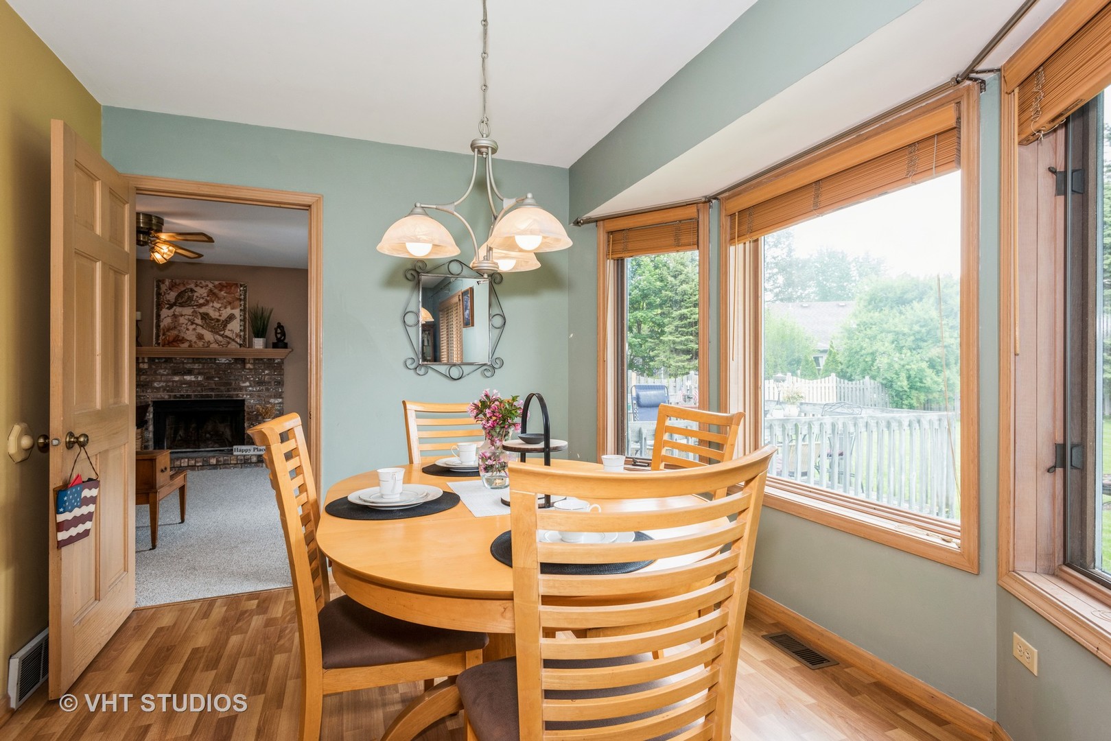 577 Yellowstone Drive Elgin, IL 60123 - Photo 8 of 30 a view of a dining room with furniture a chandelier and wooden floor