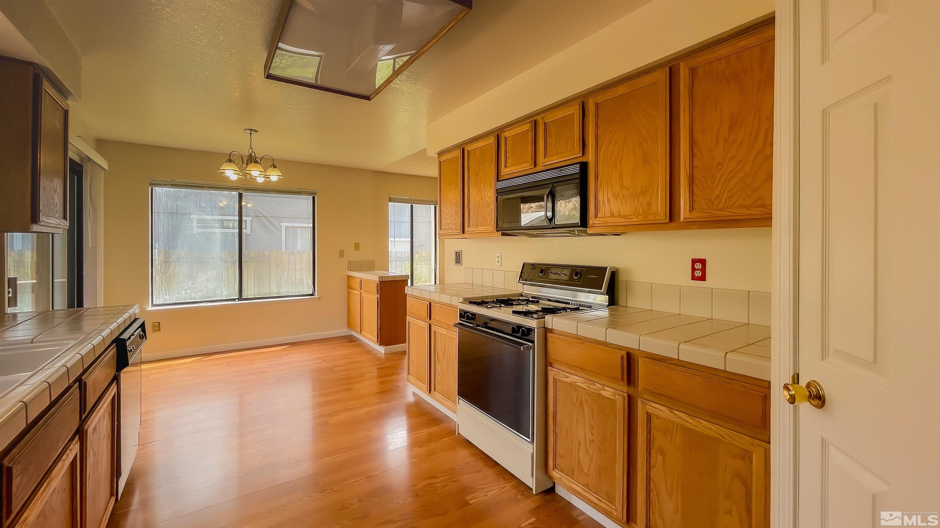 1710 Fox Run Road Reno, NV 89523 - Photo 5 of 28 a kitchen with stainless steel appliances granite countertop a stove and a refrigerator