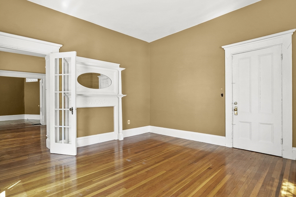 55-57 Crescent Street Waltham, MA 02453 - Photo 11 of 37 a view of an empty room with wooden floor