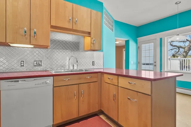 a kitchen with stainless steel appliances granite countertop white cabinets and a sink