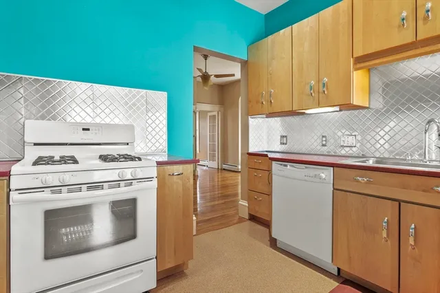 a kitchen with cabinets appliances and a sink