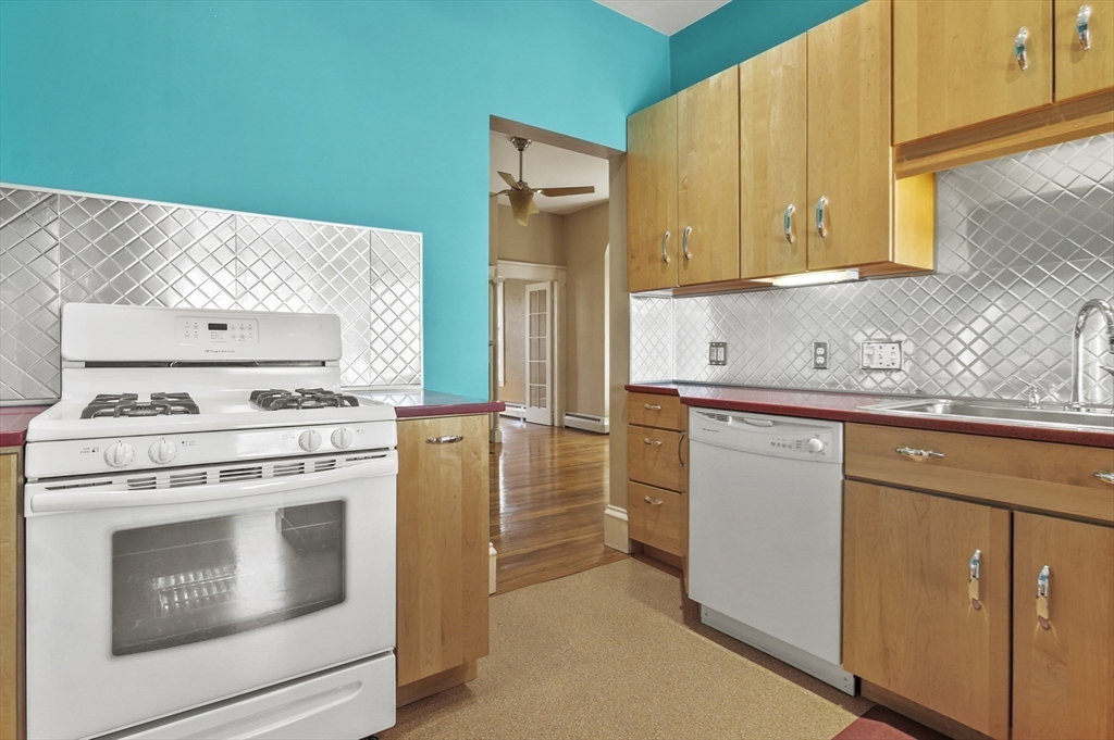 55-57 Crescent Street Waltham, MA 02453 - Photo 14 of 37 a kitchen with cabinets appliances and a sink