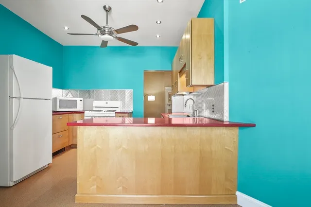 a view of kitchen with window and refrigerator