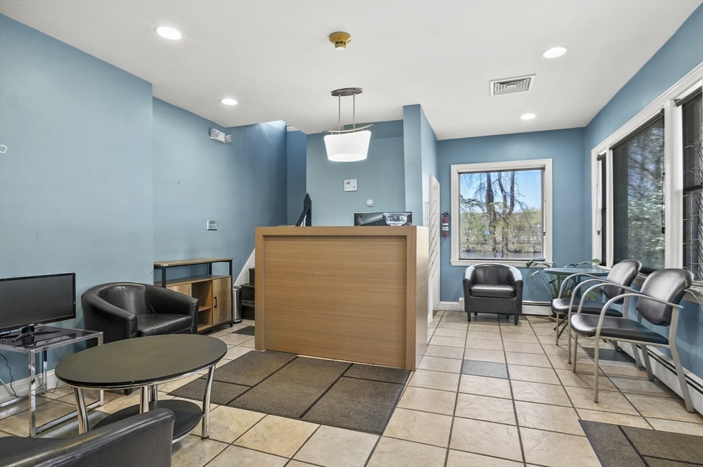 55-57 Crescent Street Waltham, MA 02453 - Photo 19 of 37 a room with furniture a rug and a view of living room