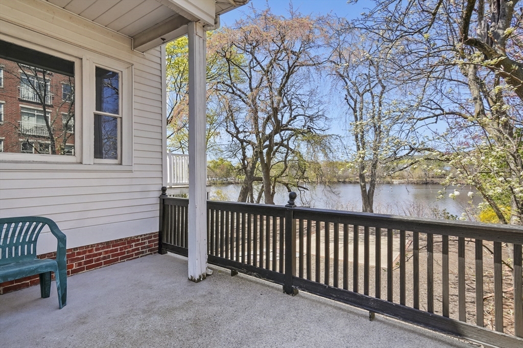55-57 Crescent Street Waltham, MA 02453 - Photo 23 of 37 a view of a porch with a bench