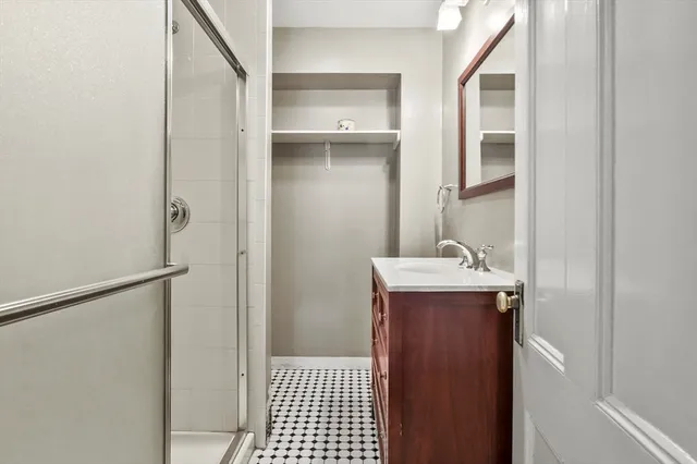 a bathroom with a sink a mirror and shower