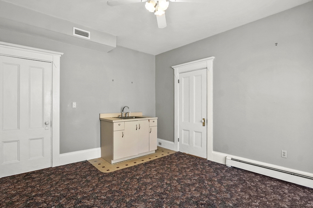 55-57 Crescent Street Waltham, MA 02453 - Photo 25 of 37 a room with a chandelier fan and a window