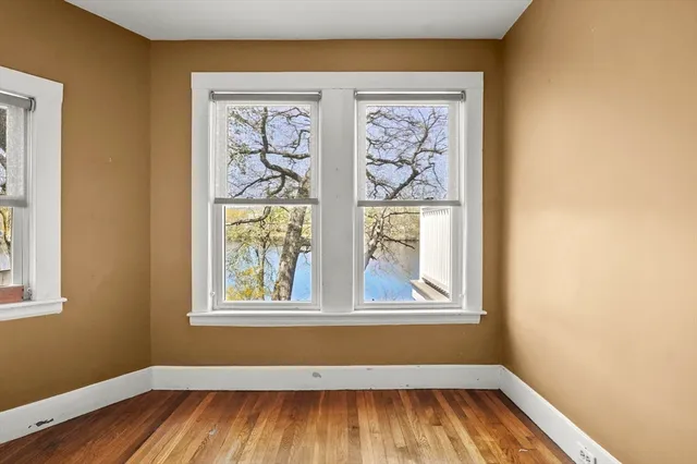 a view of room with window and wooden floor
