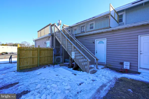 a view of a house with wooden fence