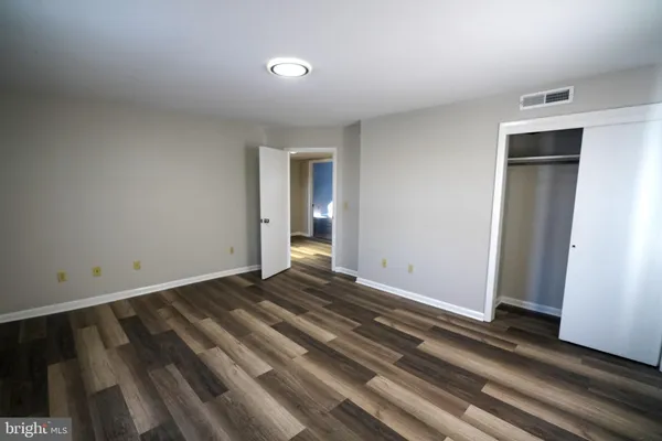 a view of an empty room and wooden floor