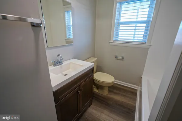 a bathroom with a sink toilet and window