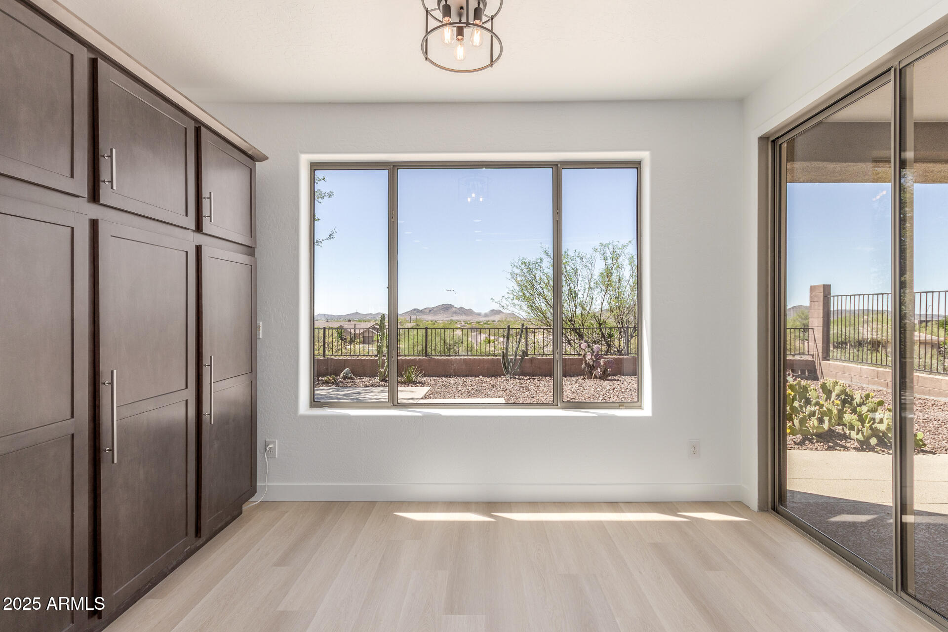 41401 North Maidstone Court Anthem, AZ 85086 - Photo 14 of 53 a view of an empty room with wooden floor and a window