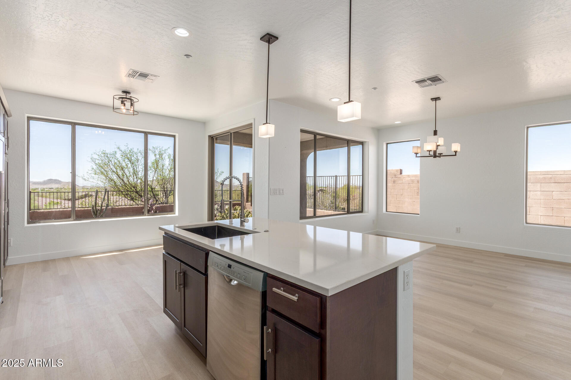 41401 North Maidstone Court Anthem, AZ 85086 - Photo 15 of 53 a kitchen with a sink chandelier and wooden floor