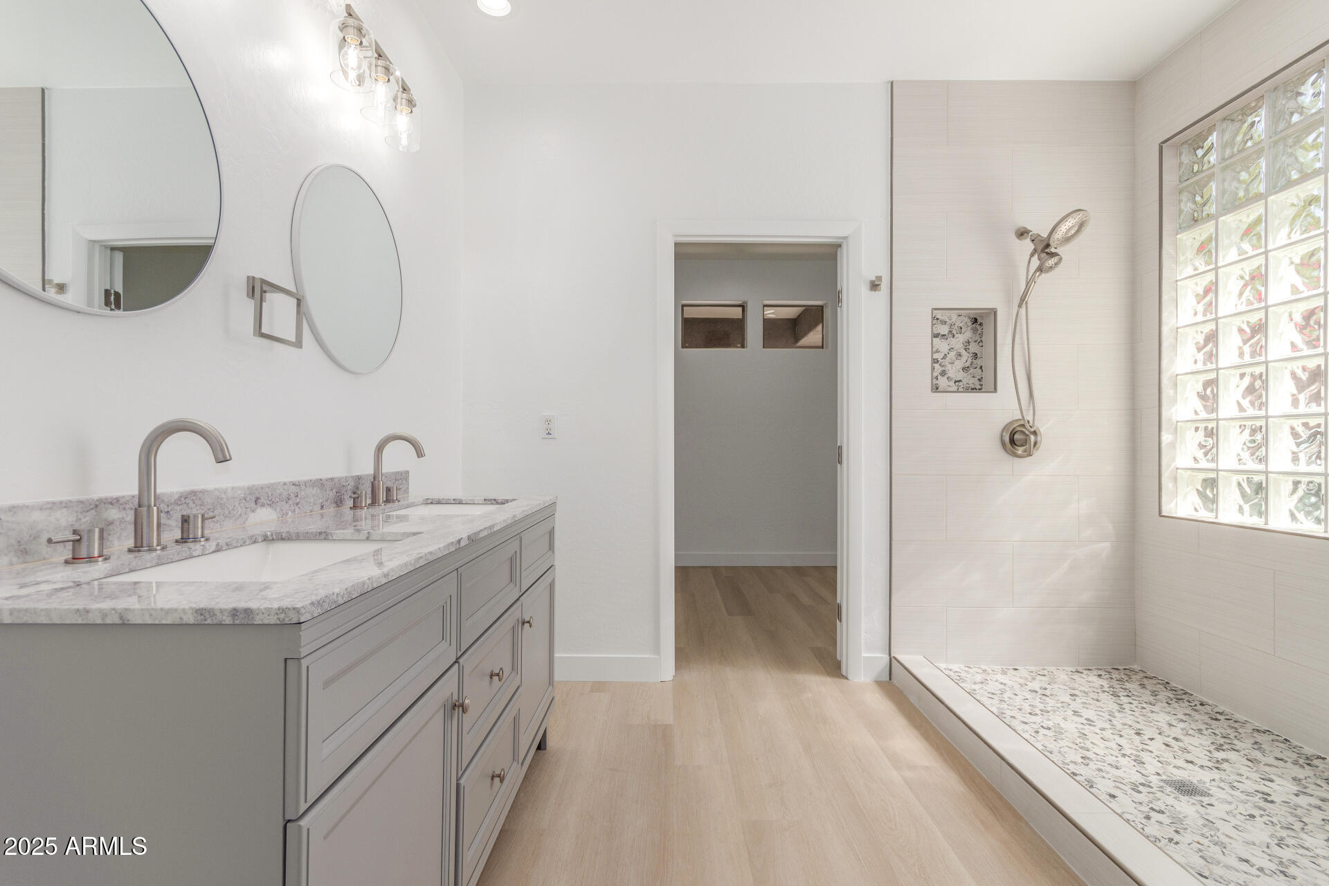 41401 North Maidstone Court Anthem, AZ 85086 - Photo 19 of 53 a spacious bathroom with a double vanity sink and a mirror