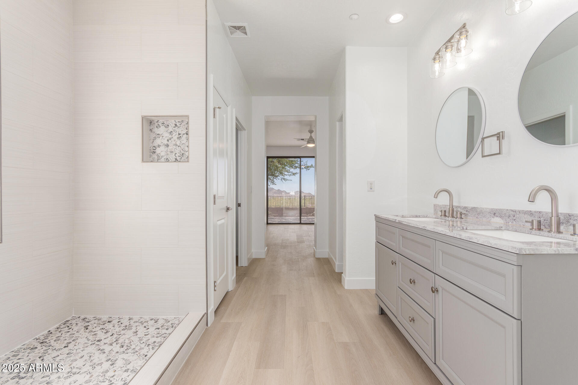 41401 North Maidstone Court Anthem, AZ 85086 - Photo 20 of 53 a spacious bathroom with a double vanity sink and mirror