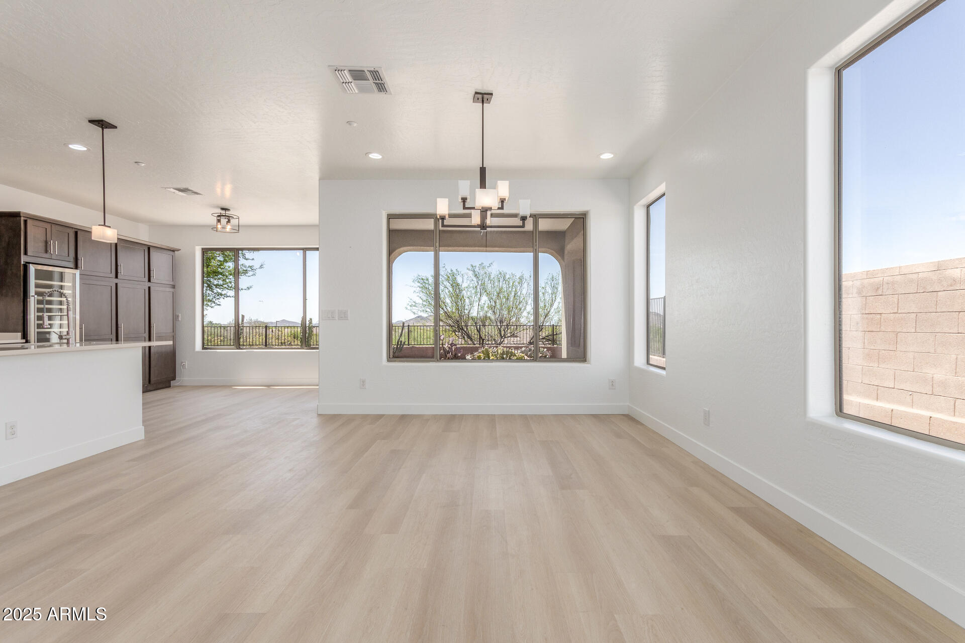41401 North Maidstone Court Anthem, AZ 85086 - Photo 7 of 53 an empty room with wooden floor and windows
