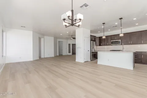 a view of a kitchen with a refrigerator and a chandelier