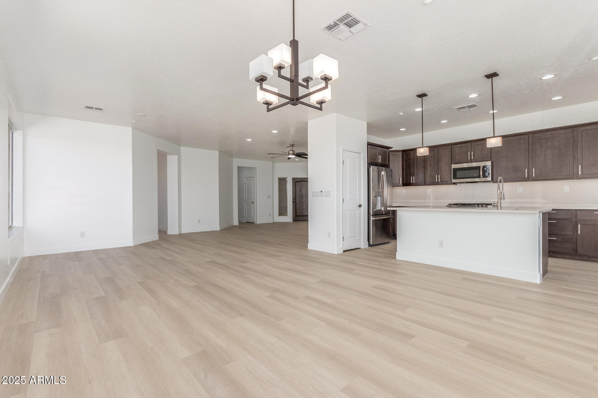 41401 North Maidstone Court Anthem, AZ 85086 - Photo 8 of 53 a view of a kitchen with a refrigerator and a chandelier