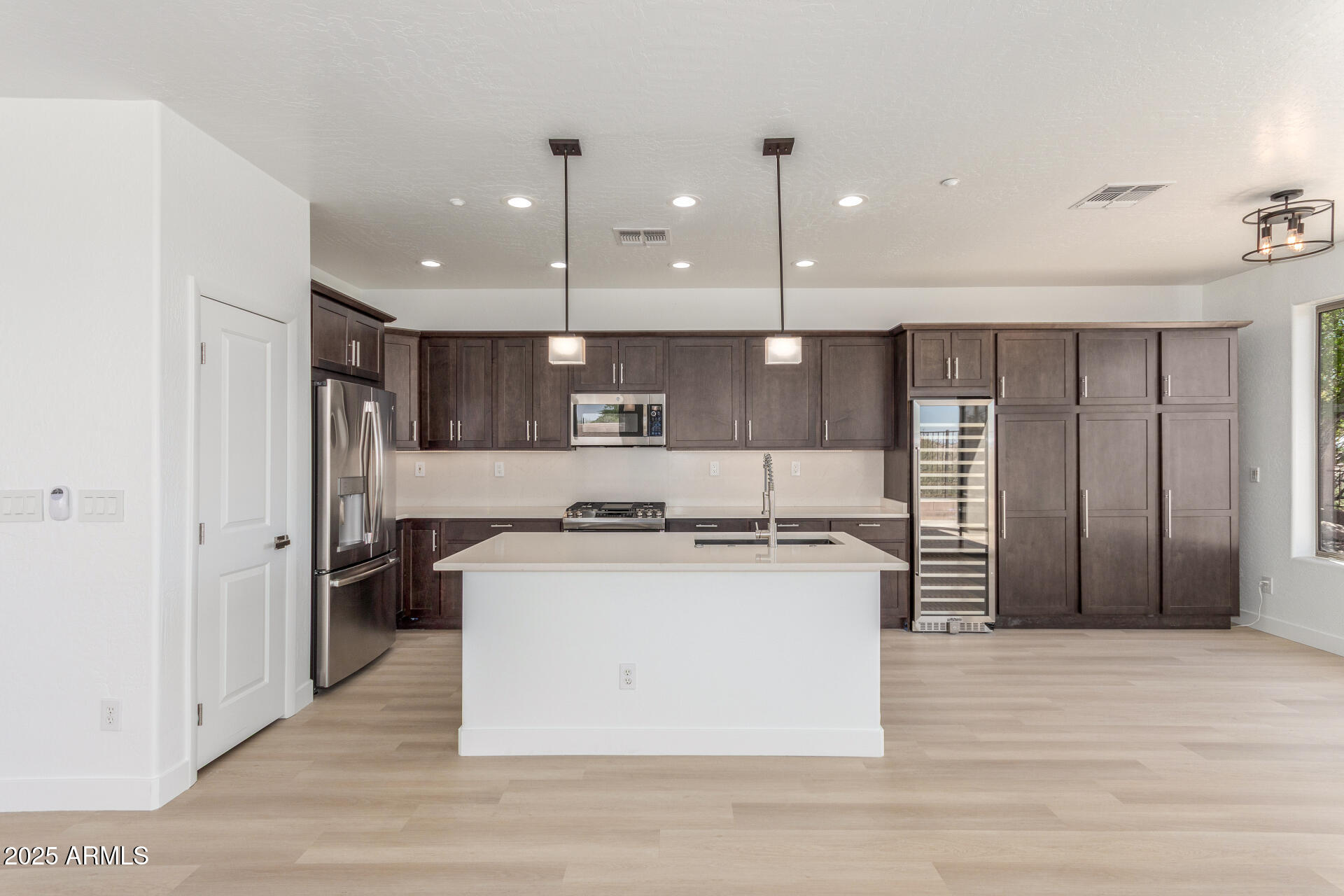 41401 North Maidstone Court Anthem, AZ 85086 - Photo 9 of 53 a kitchen with stainless steel appliances granite countertop a stove a refrigerator a sink and a oven