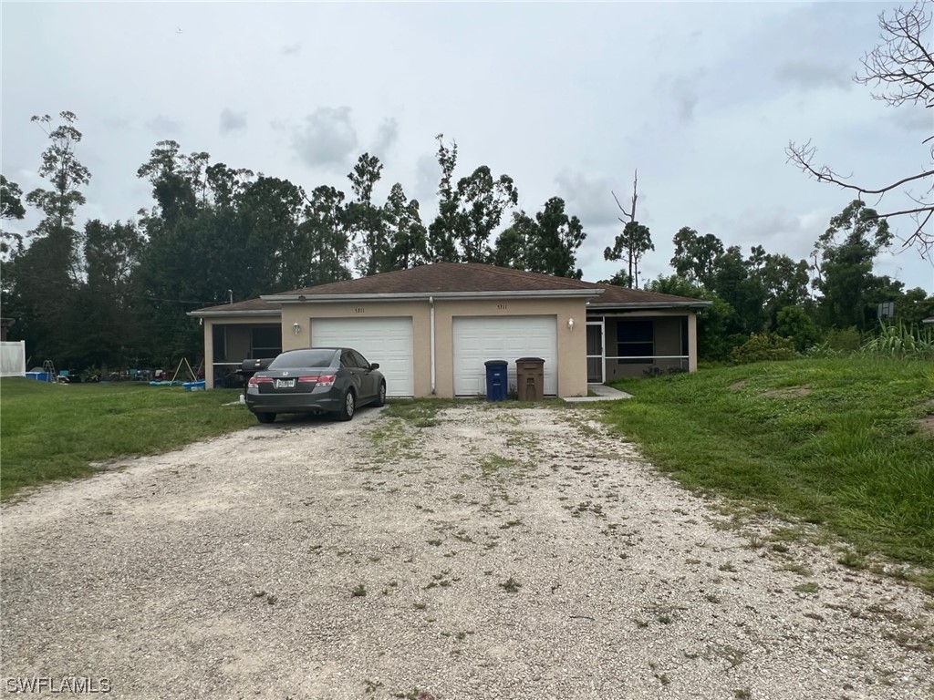5311 Banning Street Lehigh Acres, FL 33971 - Photo 1 of 21 a house view with a backyard space