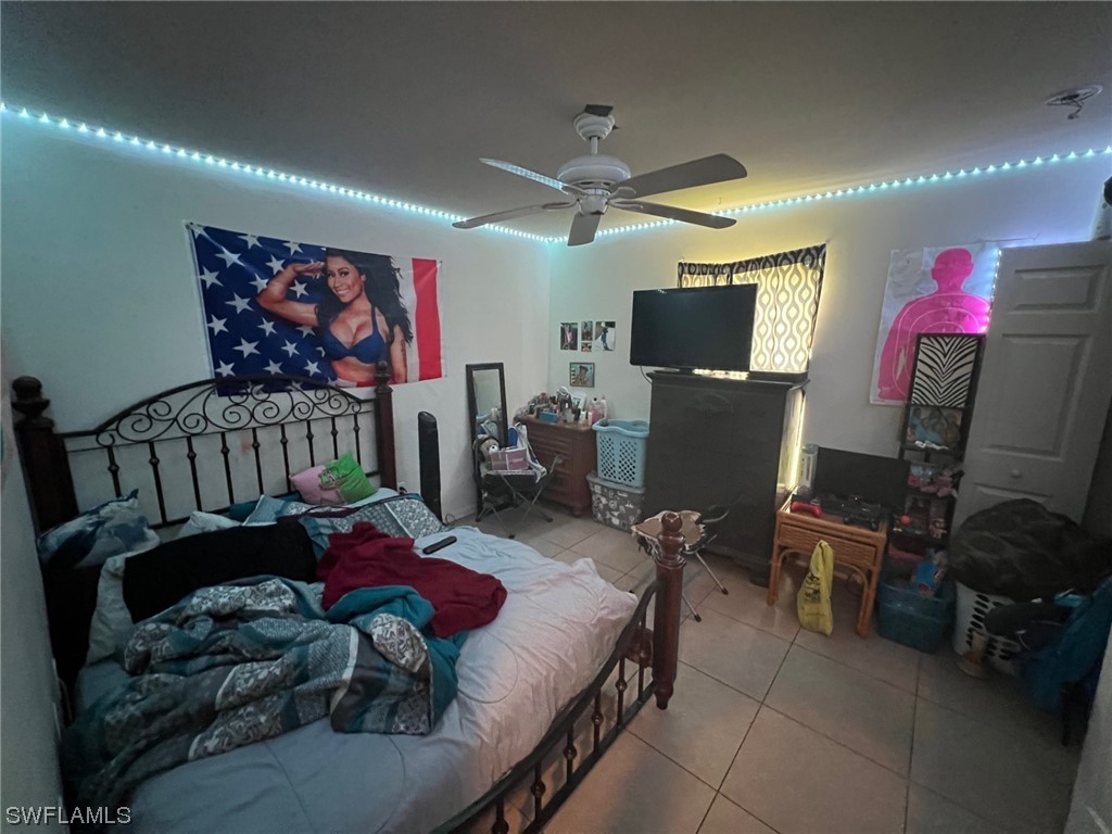 5311 Banning Street Lehigh Acres, FL 33971 - Photo 11 of 21 a bedroom with furniture and a flat screen tv