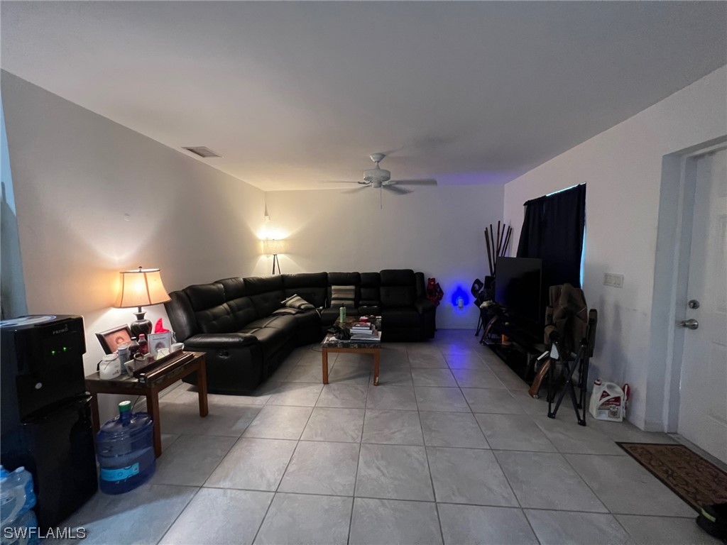 5311 Banning Street Lehigh Acres, FL 33971 - Photo 14 of 21 a couch sitting in a room next to a window