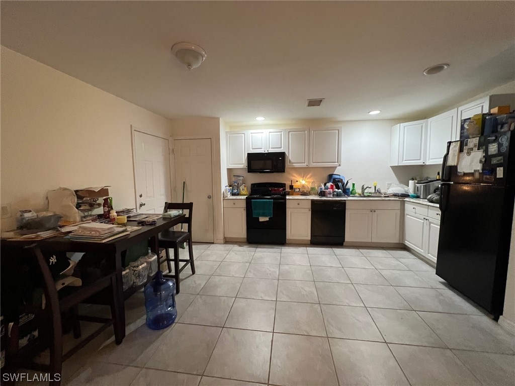 5311 Banning Street Lehigh Acres, FL 33971 - Photo 15 of 21 a kitchen with stainless steel appliances kitchen island granite countertop a sink and cabinets