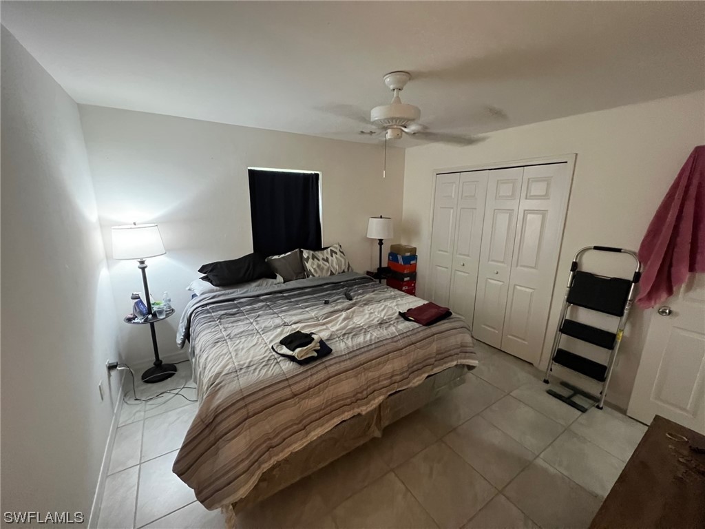 5311 Banning Street Lehigh Acres, FL 33971 - Photo 19 of 21 a bedroom with a bed and a flat screen tv