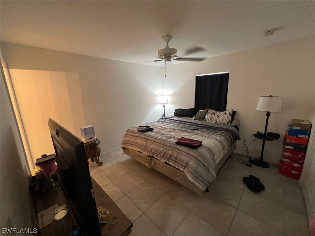 5311 Banning Street Lehigh Acres, FL 33971 - Photo 20 of 21 a bedroom with a bed and a window