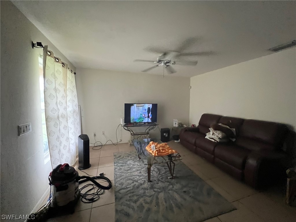 5311 Banning Street Lehigh Acres, FL 33971 - Photo 6 of 21 a living room with furniture and a flat screen tv