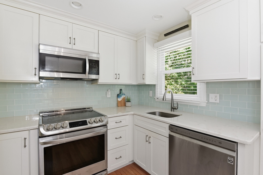 8 Emerald Way Sandwich, MA 02644 - Photo 8 of 36 a kitchen with cabinets stainless steel appliances a sink and a window