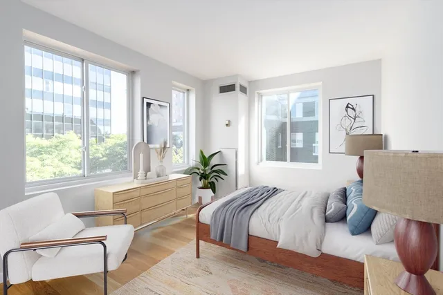 a spacious bedroom with a bed and a large window