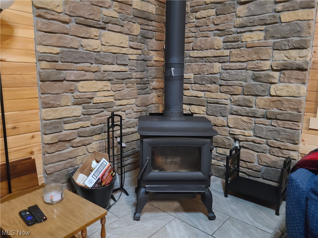 3156 Lake Road Fleming, OH 45729 - Photo 12 of 22 featuring a stone wall surrounding wood stove