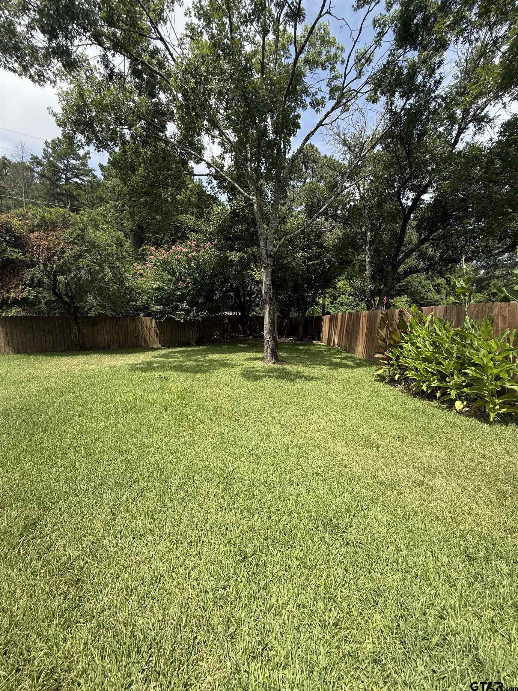 3204 Pebblebrook Circle Tyler, TX 75707 - Photo 18 of 18 a view of a house with a yard