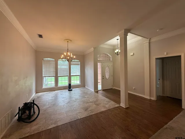 a view of a room with wooden floor