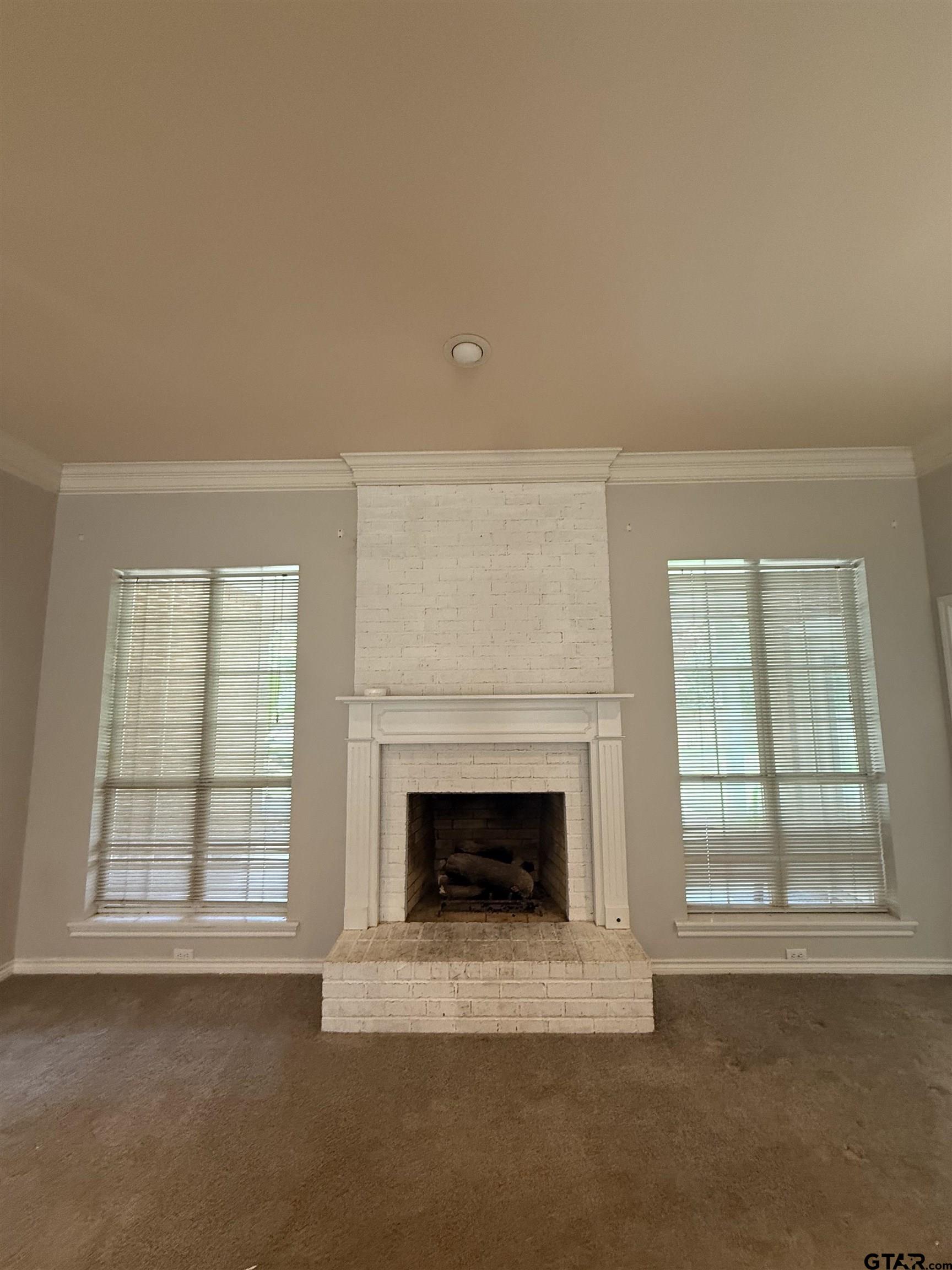 3204 Pebblebrook Circle Tyler, TX 75707 - Photo 6 of 18 an empty room with windows and fireplace