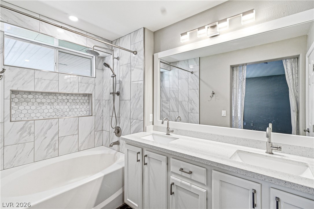 9523 Observer Street Las Vegas, NV 89123 - Photo 30 of 42 Luxurious marble tiling elevates this well-appointed bath with a convenient double vanity.