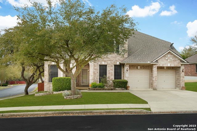 3900 Arroyo Dorado Schertz, TX 78154 - Photo 1 of 1 a front view of a house with a garden and trees