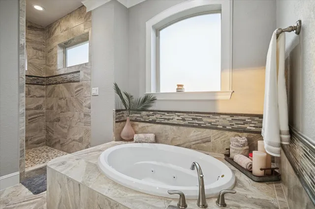 a view of walk in closet with clothes shoes and washer