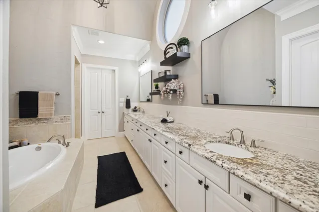 a large bathroom with a granite countertop sink a mirror and shower