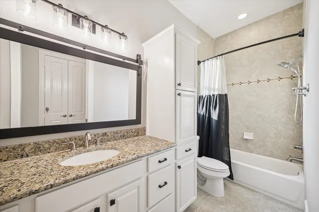 a bedroom with a bed couch and window