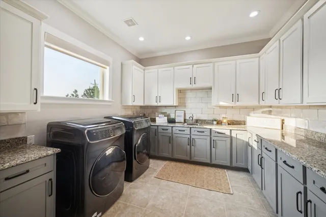 a kitchen with granite countertop white cabinets white appliances a sink and dishwasher