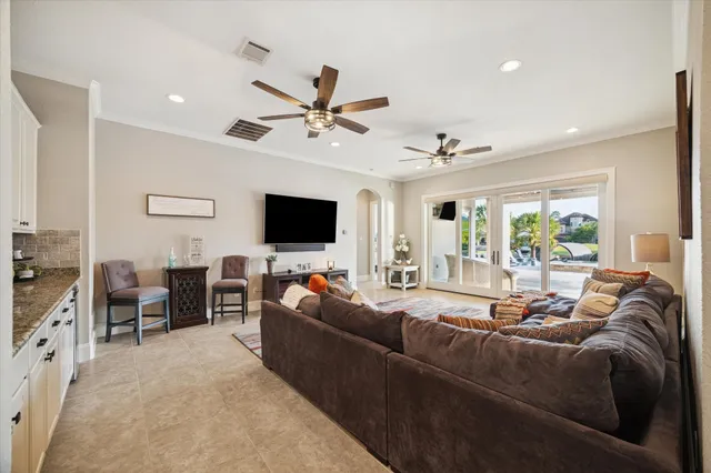 a living room with furniture and a chandelier