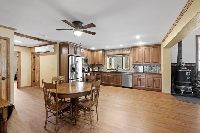 a kitchen with stainless steel appliances granite countertop wooden cabinets a sink and dishwasher