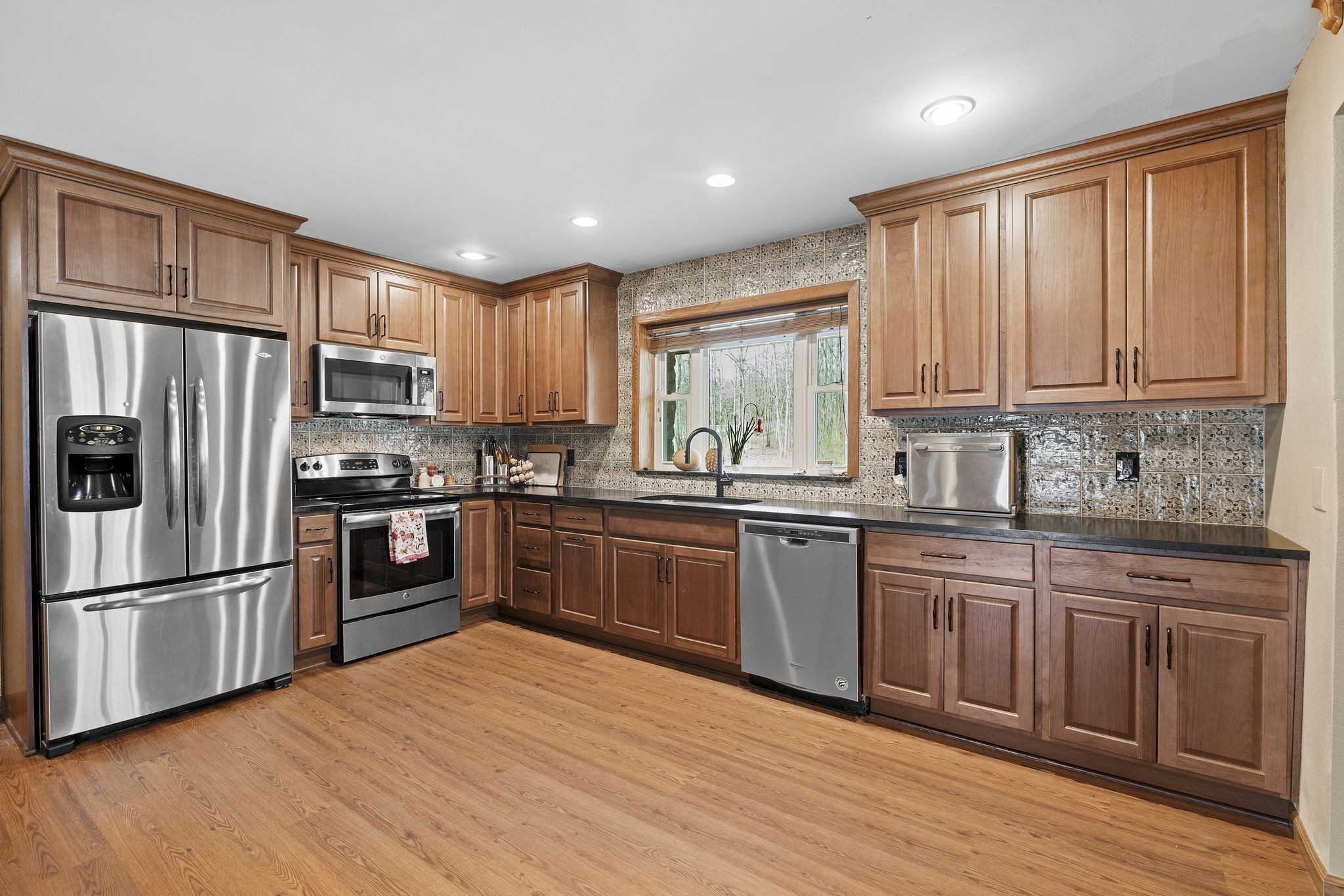 10669 South Windrow Road Rockvale, TN 37153 - Photo 14 of 53 a kitchen with granite countertop stainless steel appliances a refrigerator sink and microwave