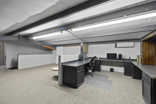 a view of a room with a chandelier fan and a window