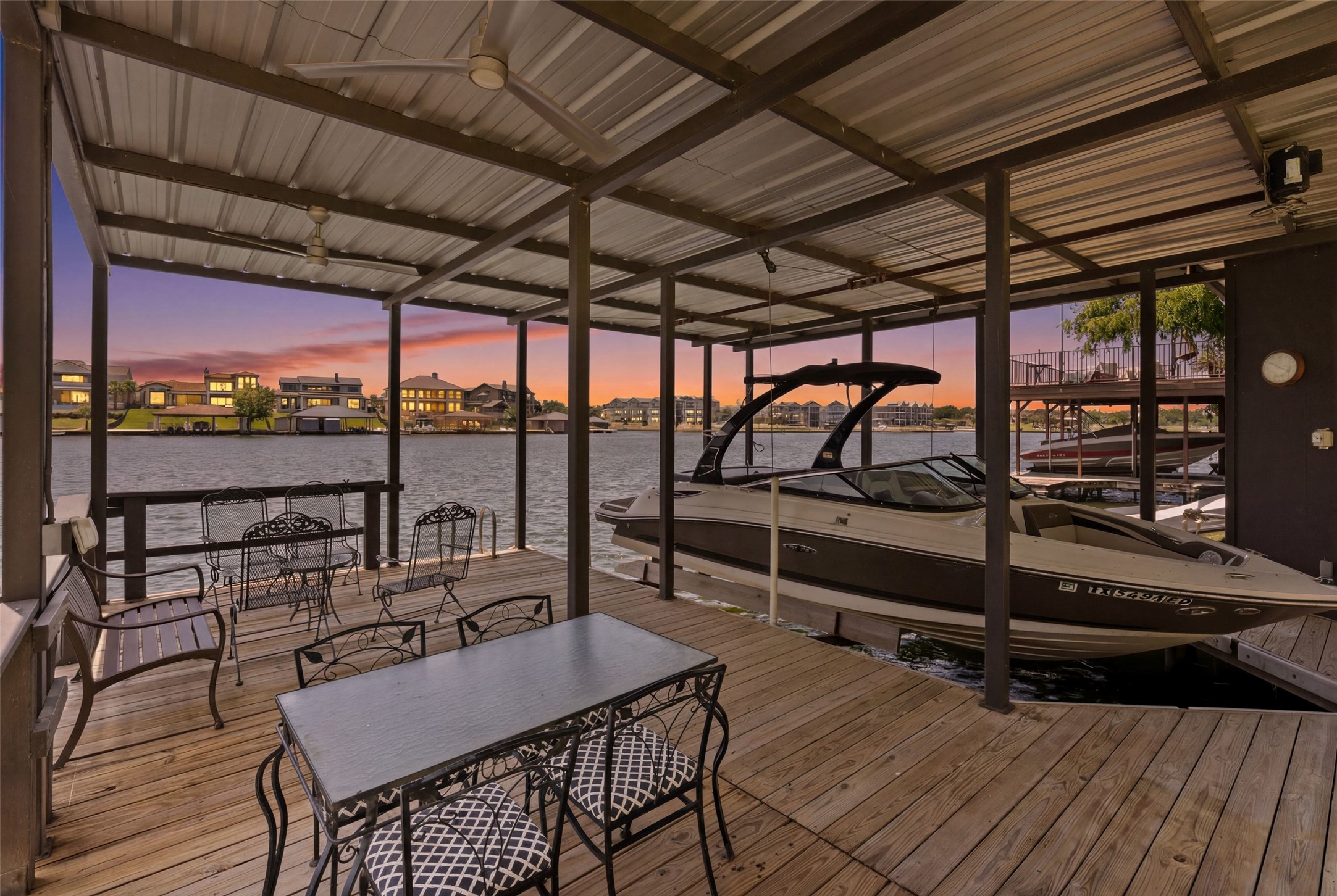 141 Perry Lane Kingsland, TX 78639 - Photo 11 of 40 A spacious covered dock with boat lift and ample seating provides waterfront recreation and sunset views.