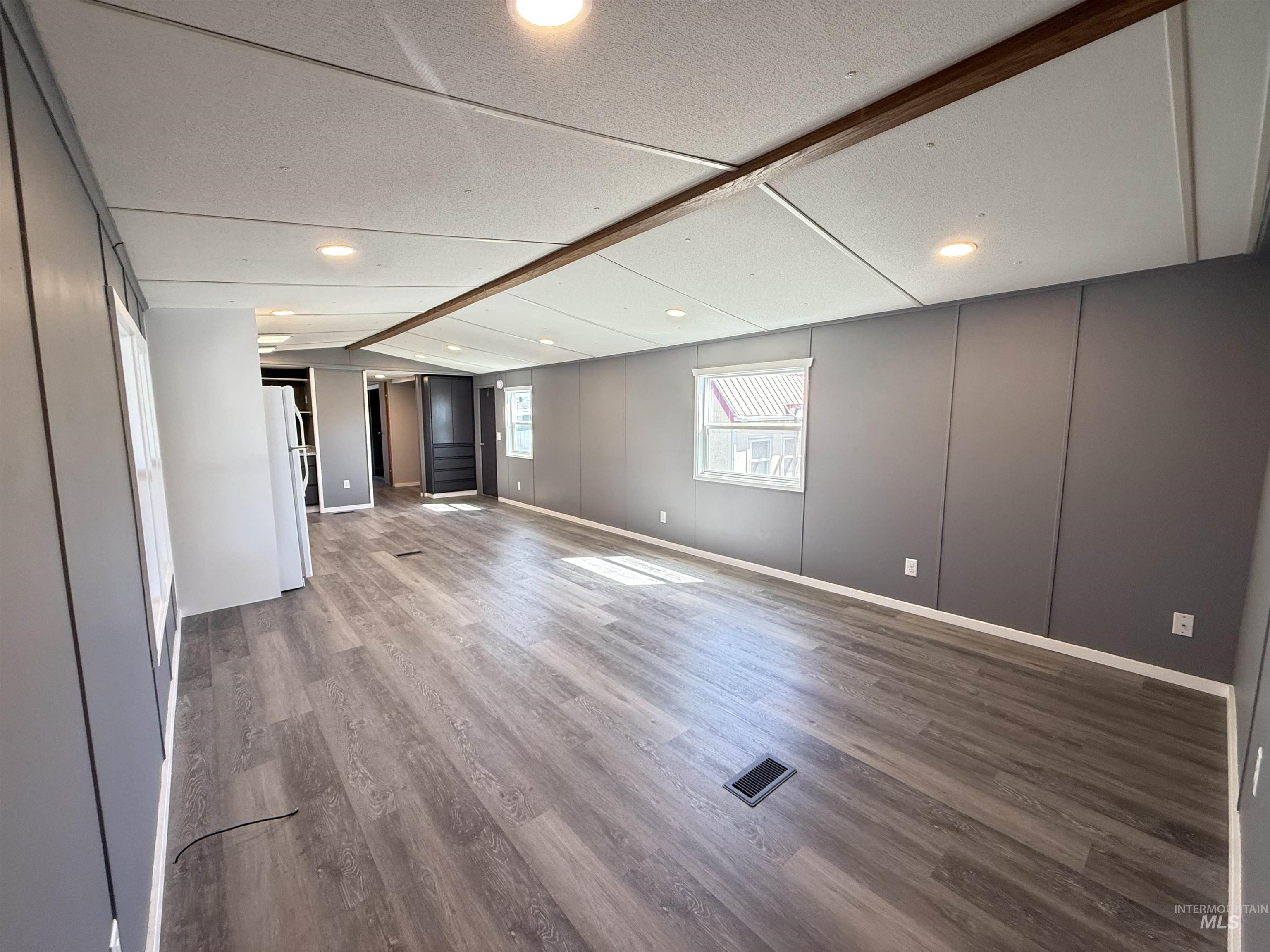 2015 6th Avenue, Unit 321 Clarkston, WA 99403 - Photo 9 of 34 Unfurnished living room featuring lofted ceiling and light wood-style floors